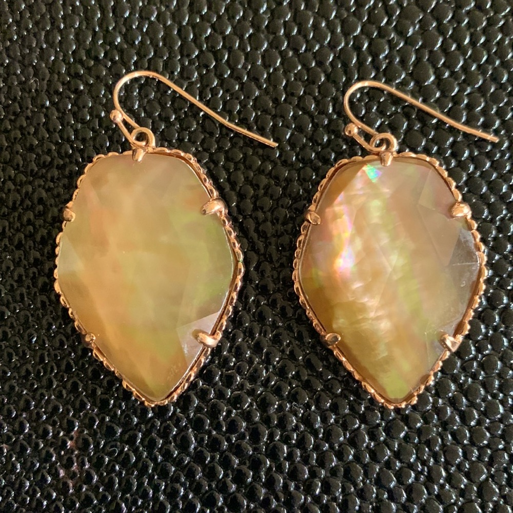 Kendra Scott rose gold earrings.